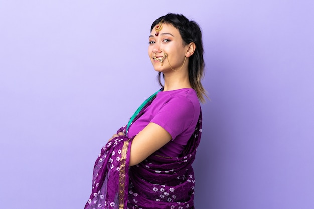 Indian woman isolated on purple with arms crossed and looking forward