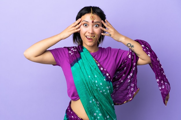 Indian woman isolated on purple with surprise expression