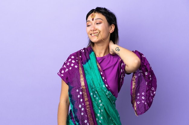 Indian woman on purple wall laughing