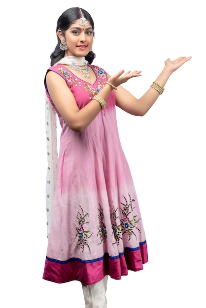 Indian woman in traditional Anarkali dress standing with an open palm and showing something