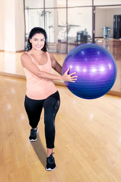 Indian woman training with a yoga ball