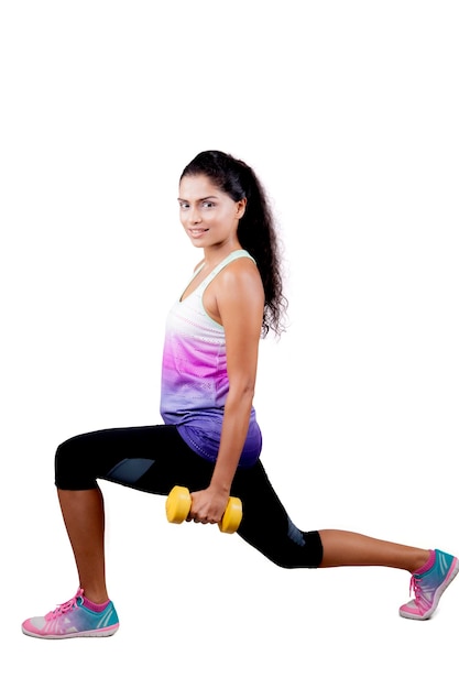 Indian woman warming up before workout on studio