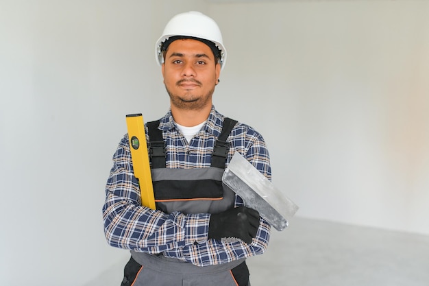 Indian worker makes repairs in an apartment