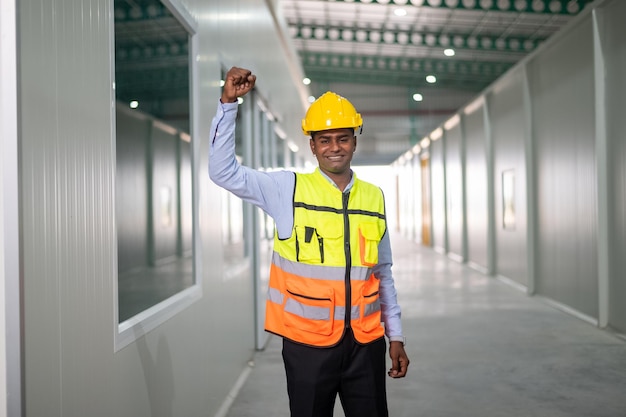 Photo indian worker standing confident in factory background