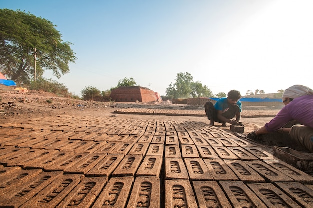 Indian workers making traditional bricks by hand in the brick factory