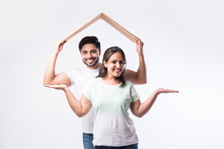 फोटो indian young family couple and real estate concept - buying or rental, standing against white background