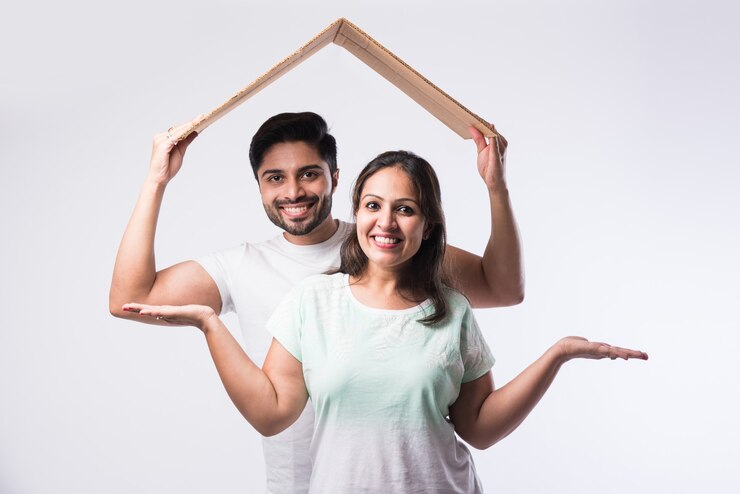 फोटो indian young family couple and real estate concept - buying or rental, standing against white background