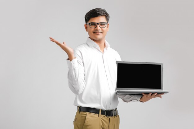 Indian young man holding a laptop