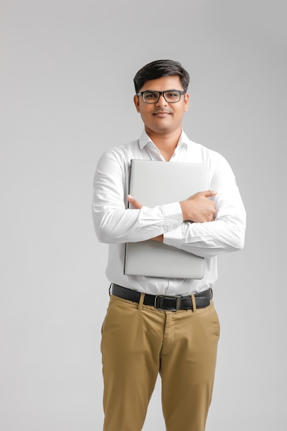 Indian young man holding a laptop