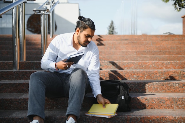 Indian young student carrying books