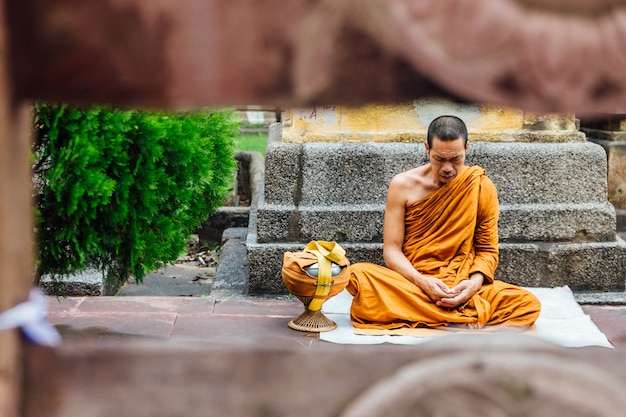 Indiase boeddhistische monnik in meditatie dichtbij de Bodhi-boom dichtbij Mahabodhi-tempel