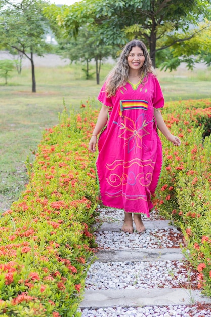 Indigenous woman walking in traditional clothing in the city park