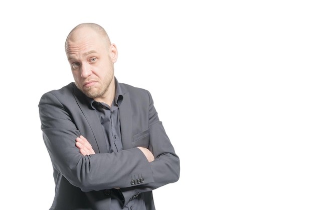 Photo indignant bald man in a gray suit with arms crosse isolated