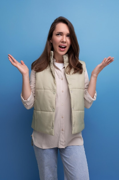 Indignant brunette young woman in casual style in studio