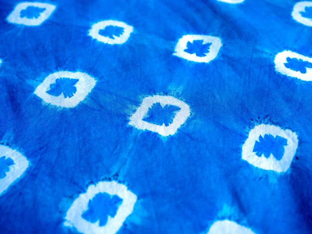 Indigo blue fabric tie dye pattern background. indigo-dyed fabric texture with abstract ethnic graphic motif pattern