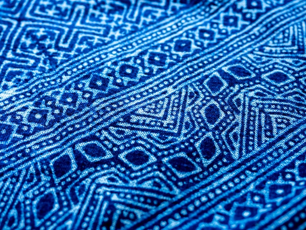 Indigo blue fabric tie dye pattern background. Indigo-Dyed fabric texture with abstract ethnic graphic motif pattern.