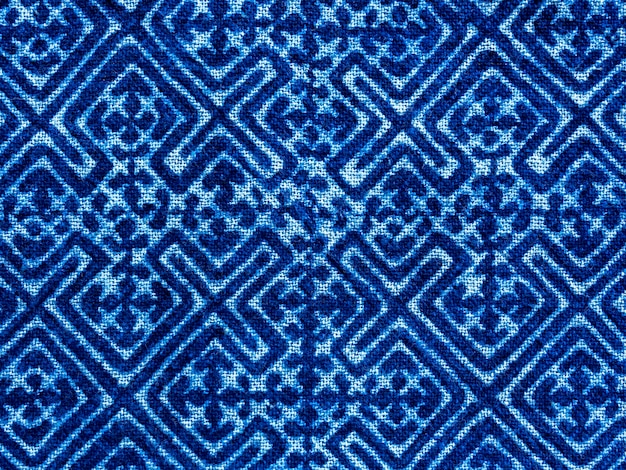 Indigo blue fabric tie dye pattern background. Indigo-Dyed fabric texture with abstract ethnic graphic motif pattern.