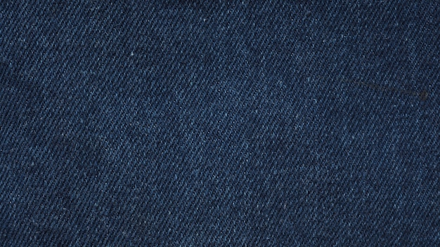 Photo indigo blue jeans textile for texture and background.