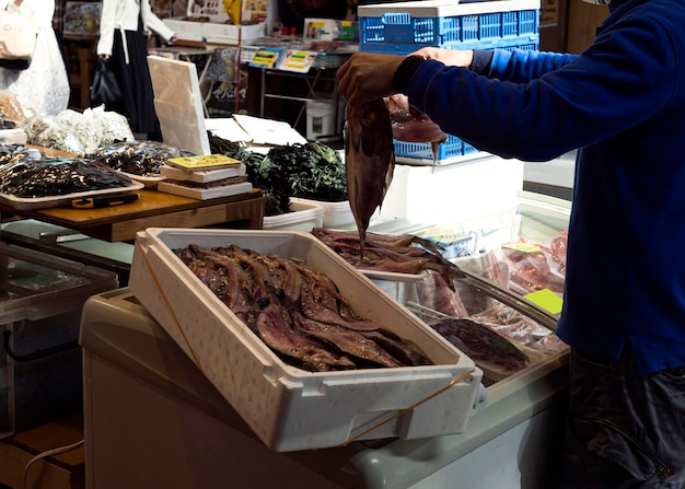 Individual searching for fresh fish at the market