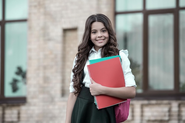 For individual study. Happy child hold study books outdoors. Formal education. Back to school essentials. School fashion. Private teaching. Home schooling. Learn well today, vintage filter.
