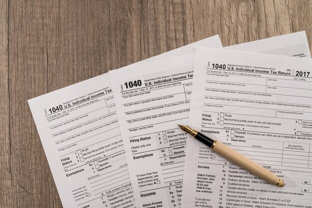 Individual tax form 1040 with pen and glasses