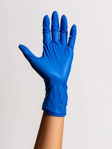 Individual wearing blue rubber gloves grasping object against blank backdrop in closeup view