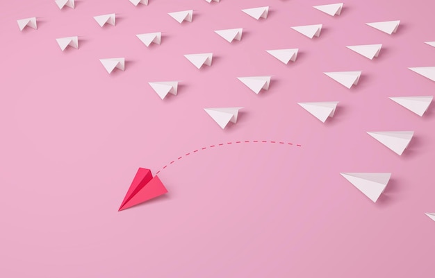 Individuality Women39s leadership concept Individual and unique leader pink paper airplane changing direction