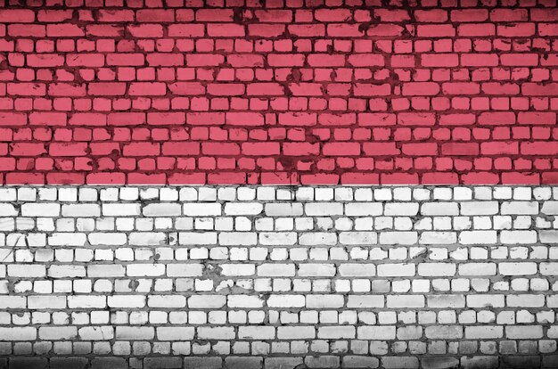 indonesia flag is painted onto an old brick wall