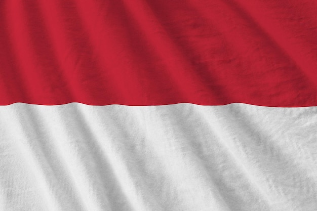 Photo indonesia flag with big folds waving close up under the studio light indoors the official symbols and colors in banner