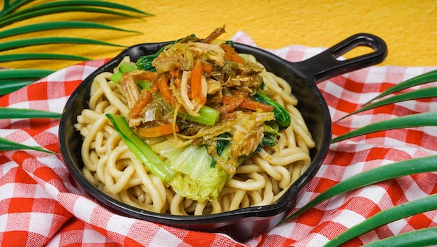 Indonesian famous street food mie ayam noodles with chicken Served in frying pan