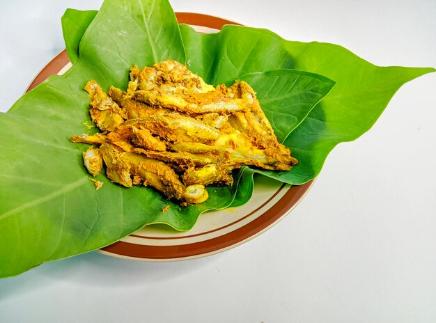 Photo an indonesian food called pepes ikan on green leaves isolated on an unclean background