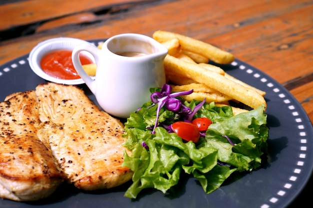 Indonesian food - fried cassava with sauce and green vegetables