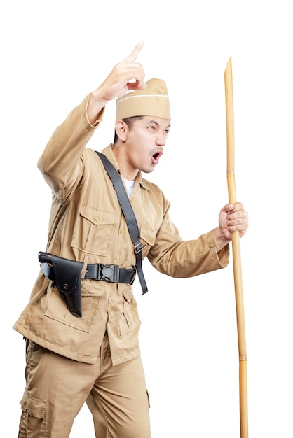 Indonesian freedom fighter standing while holding sharpened bamboo stick