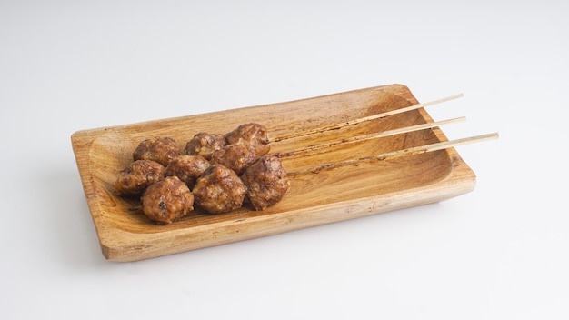 Indonesian grilled meatballs bakso bakar served with wooden plate Selective Focus