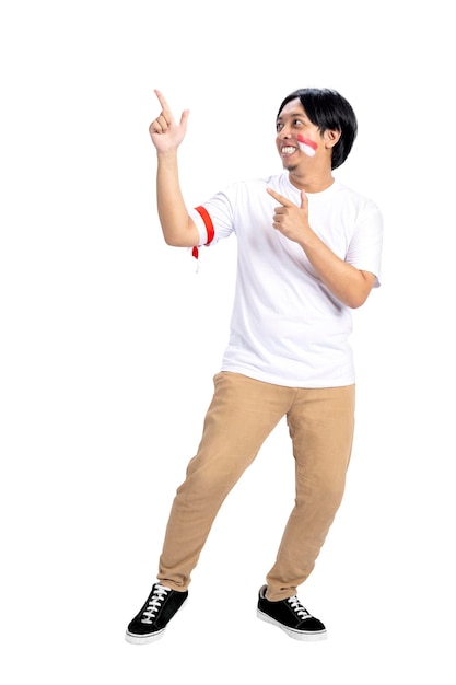 Indonesian man celebrates Indonesian independence day on 17 August while pointing to something