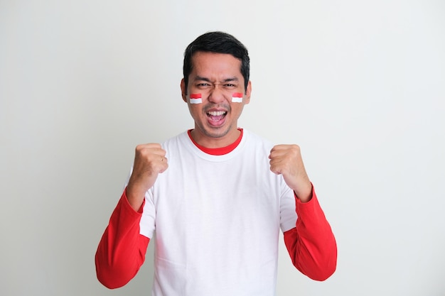 Indonesian man clenched both fist showing excitement when celebrating independence day