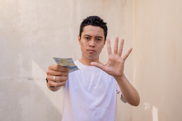 Indonesian man rejected pose and gesture with hold the money