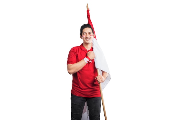 Indonesian men celebrate Indonesian independence day on 17 August by holding the Indonesian flag