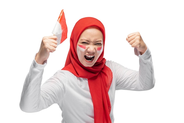 Indonesian women celebrate Indonesian independence day on 17 August by holding the Indonesian flag