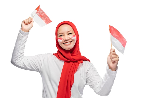 Indonesian women celebrate Indonesian independence day on 17 August by holding the Indonesian flag