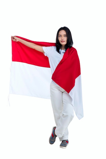 Indonesian women celebrate Indonesian independence day on 17 August by holding the Indonesian flag