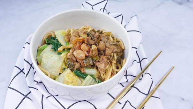 Indonesisch eten Mie Ayam of Bami ayam noedels met kip en geserveerd op witte kom