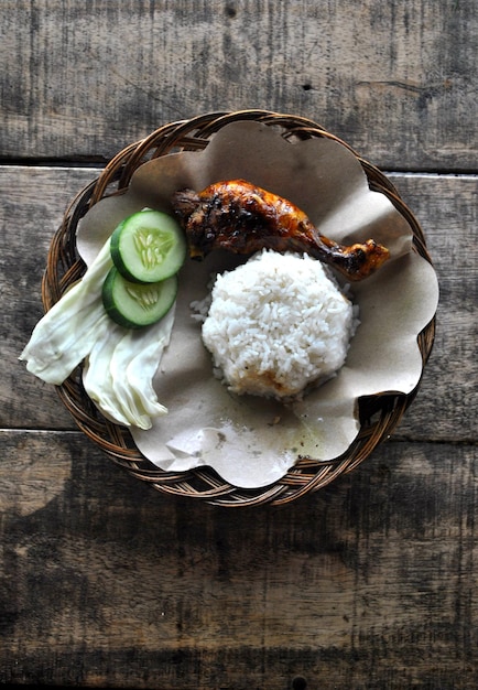 Indonesische geroosterde kippengrill met zoete sojasaus op een hoge hoek van het eten op tafel