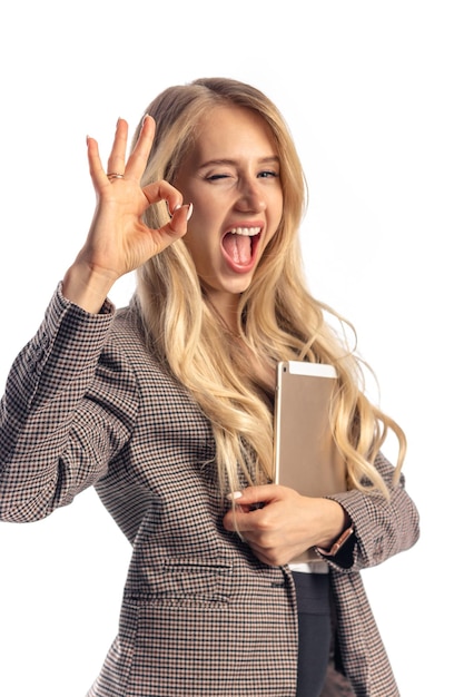 Indoor female european blond business woman in office holding tablet free photo