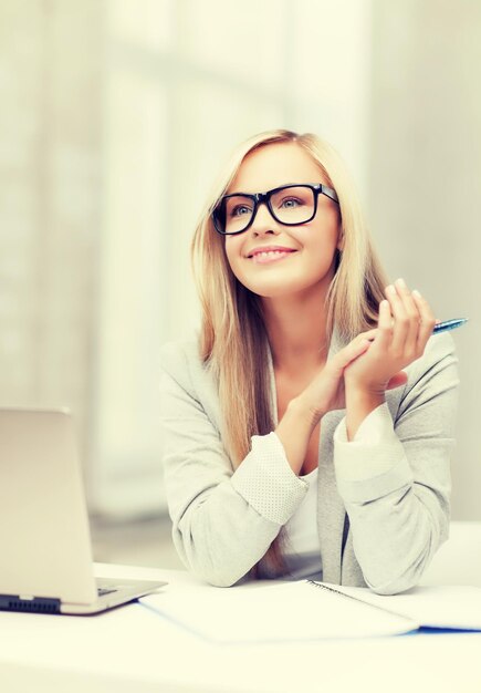 indoor picture of smiling woman with notebook and pen