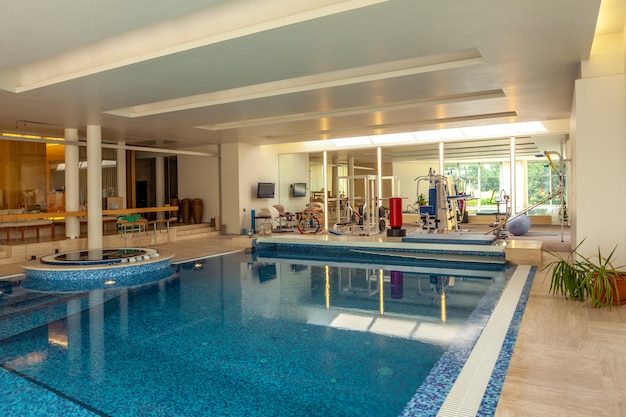 Indoor pool and gym for sports and relaxation in comfortable mansion