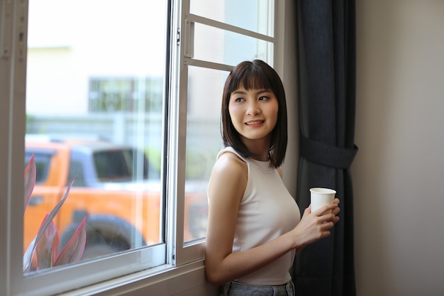 Indoor portrait of beautiful young woman posed at home