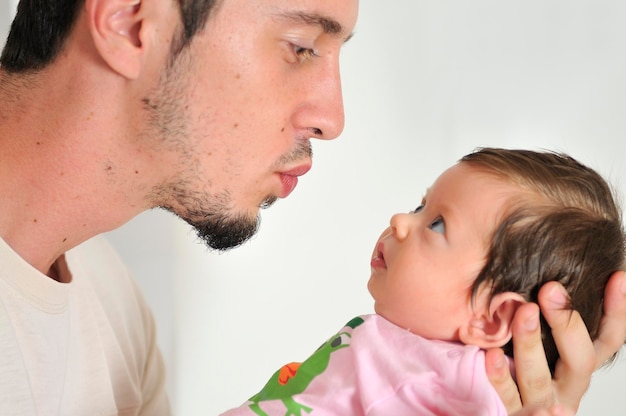 indoor portrait with happy young famil and  cute little babby