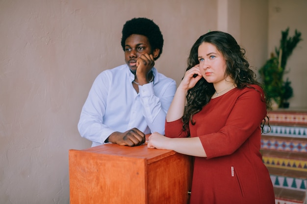 Indoor portrait of young interracial couple.