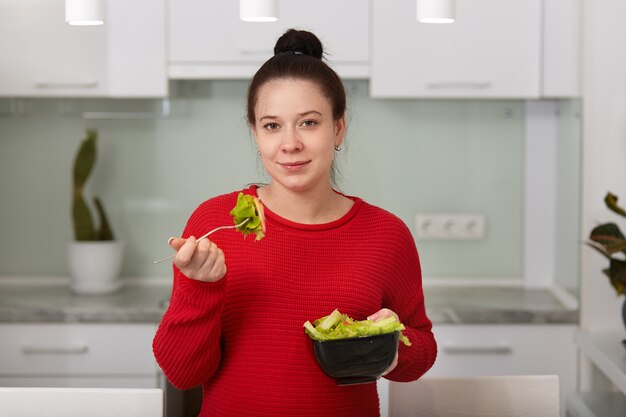 Indoor shot of brunette woman with hairstyle bun